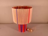 a lamp that is made out of strips of wood