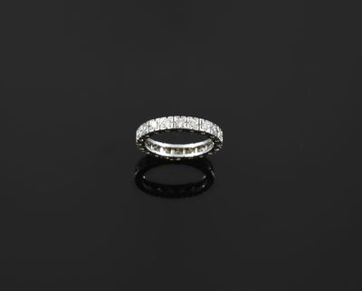 a diamond eternity ring on a black surface