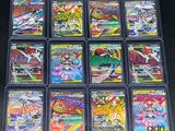 a close up of a collection of pokemon trading cards in plastic cases