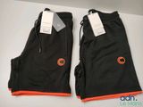 a pair of black pants with orange trims on them