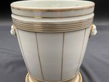 an image of a white and gold vase on a black background
