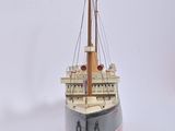 a small model of a boat on a white surface