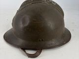 an old helmet is sitting on a white surface with a white background