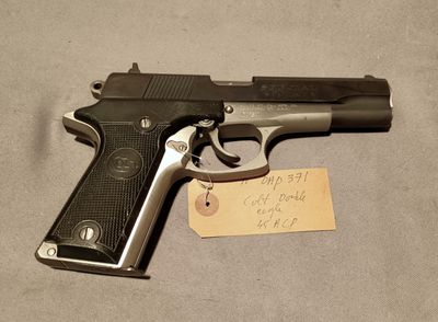 an old gun with a note attached to it on a table