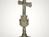 an old bronze cross on a pedestal with a cross on top of it