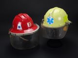 two hard hats that are next to each other on a black background