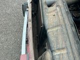 a truck with a flat bed sitting on the side of the road