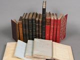 several old books are stacked on top of each other on a table