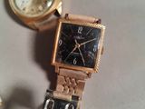 two watches sitting next to each other on a table