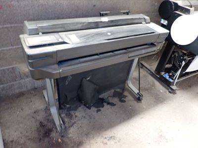 a piano sitting next to a printer in a room