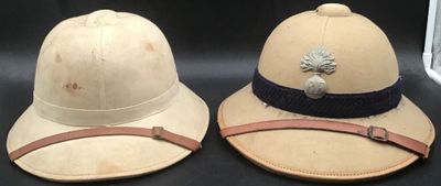 two hats that are sitting next to each other on a table