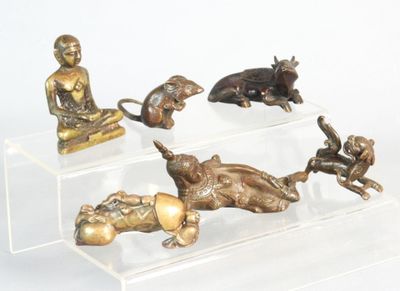 four statues of animals on a clear display case