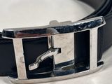 black leather belt with a silver buckle on a white surface