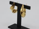 pair of gold plated earrings on a black stand on a white background