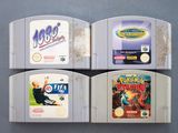 three nintendo game cartridges sitting on top of each other on a table