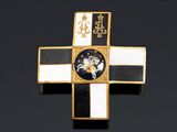 a close up of a cross on a black surface