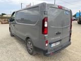 a grey van that is parked in a parking lot