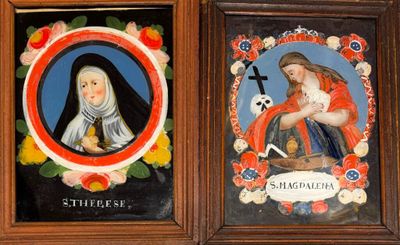 two framed pictures of a woman holding a baby and a nun
