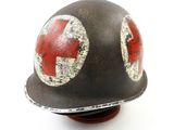 an image of a helmet with a red cross painted on it