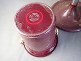 two red jars sitting next to each other on a table