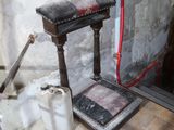 a bathroom with a toilet and a mirror on the floor