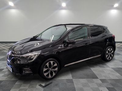 a black car is parked in a room with a checkered floor