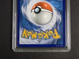 a pokemon card in a plastic holder on a table