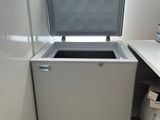 an image of a freezer in the corner of a kitchen