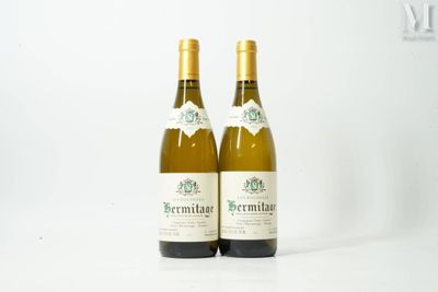 two bottles of white wine sitting next to each other on a table