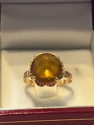 a gold ring with a citrine stone in it