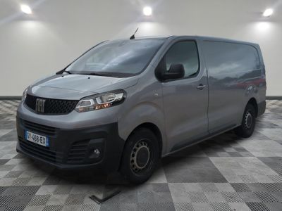 the silver van is parked on a checkered floor in the garage
