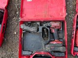 three tools in a red case sitting on the ground next to each other
