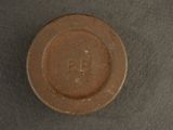 a brown plate with a brown lid on a table