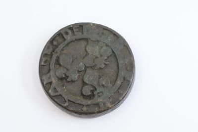 a close up of a coin on a white surface