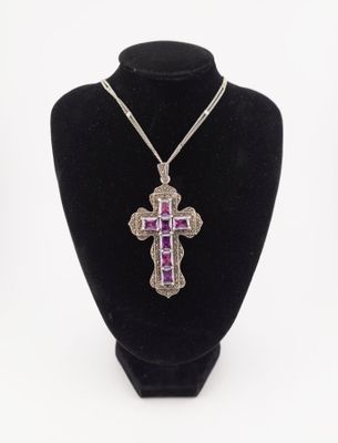 a necklace with a purple cross on a black mannequin