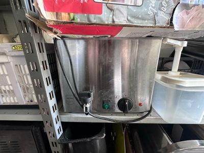 an image of a commercial coffee maker on a shelf