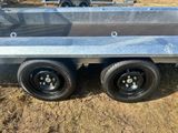 the trailer is parked in the dirt on the side of the road