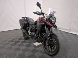 a motorcycle that is parked in a room with a checkered floor