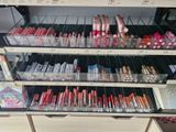 a lot of lipsticks on the shelves in the store