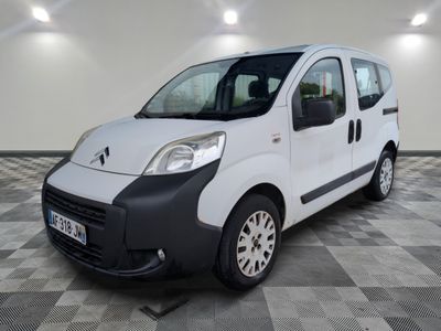 la petite camionnette blanche est garée sur un carrelage à carreaux