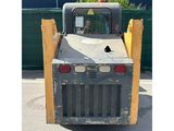 an image of a small construction vehicle parked in a parking lot