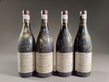 four bottles of wine are lined up on a table
