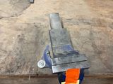 a piece of metal that has been placed on a piece of wood