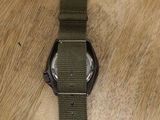 an image of a watch sitting on top of a wooden table