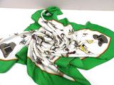 green and white scarf with a picture of a cowboy and a cow