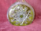 a glass vase with a star design on it on a pink surface
