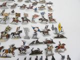 a lot of toy figurines of people riding horses and horses