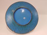 a blue and brown plate with a diamond in the center