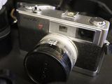 a silver camera sitting on top of a black table