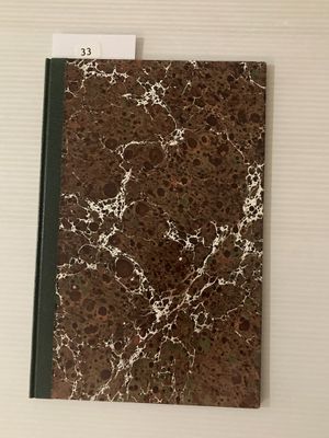 un cahier marbré marron et blanc, surmonté d'un bloc-notes